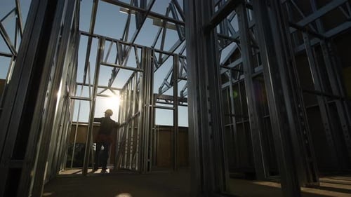 Construction Worker Inside Building Frame Reading Blueprints