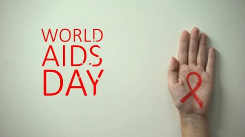 December 1st World AIDS Day, Female Hand With Red Ribbon, Prevention Campaign