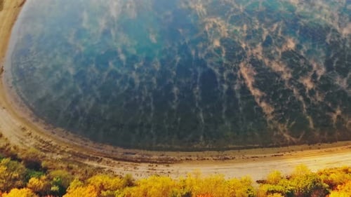 Beautiful dramatic autumn landscape of lake in the multicolored forest