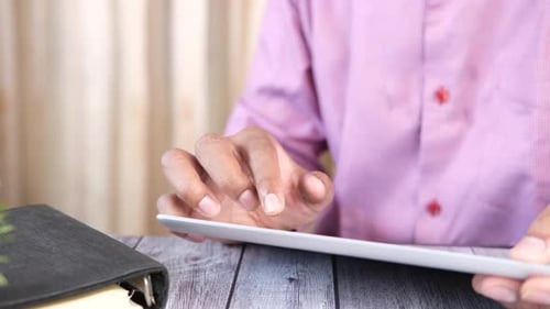 Businessman Using Digital Tablet on Office Desk