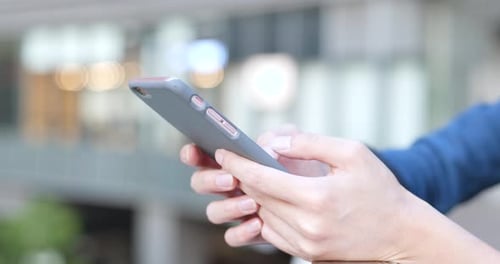 Adult Using Smartphone in Urban Environment