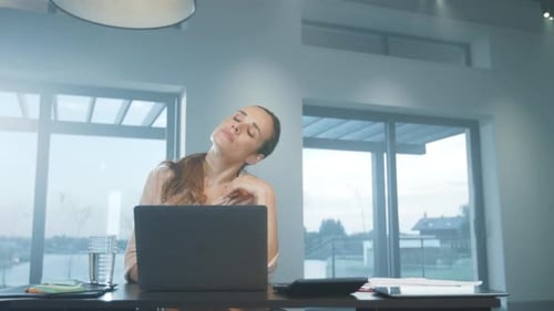 Business Woman Stretching Arms. Tired Woman Relaxing at Remote Workplace