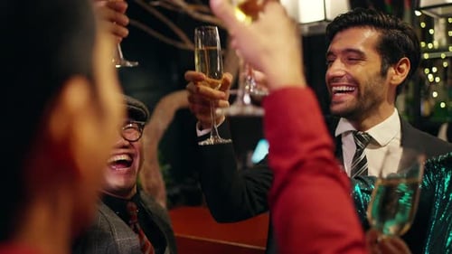 4K Group of people celebrating holiday event with toasting champagne glasses together at luxury bar