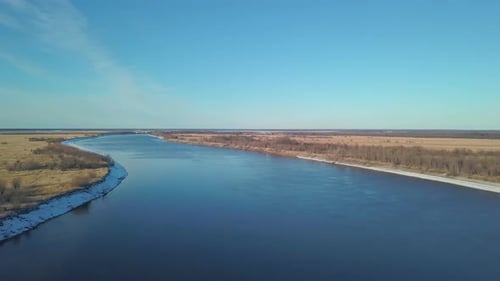 Top View of Beautiful Blue River on Background of Fields and Sky