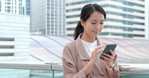 Woman Using Smartphone in Urban Setting