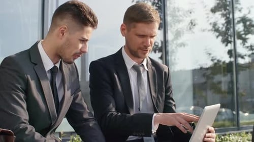 Business Partners Discussing Project Outdoors