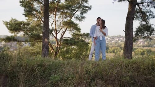 A Beautiful Girl and Boy Hugging in a Park