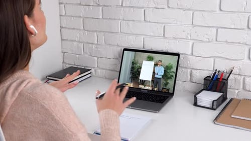 Woman Attends Virtual Meeting with Man on Laptop