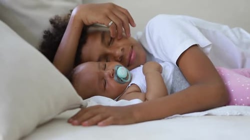 Child Sleeping Peacefully with Baby