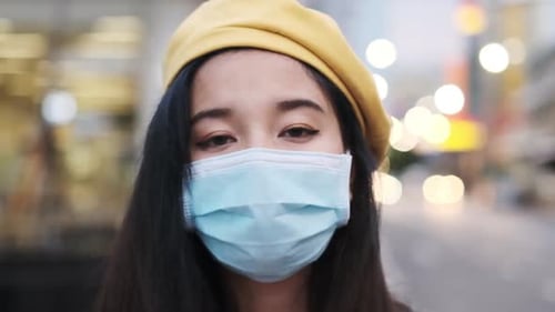 Young Woman Wearing Mask and Beret on City Street