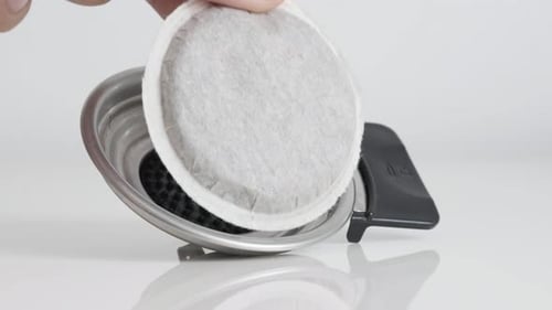 Coffee pod putting on holder close-up 4K footage