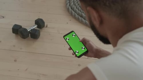 Sportsman With Smartphone At Gym Studio