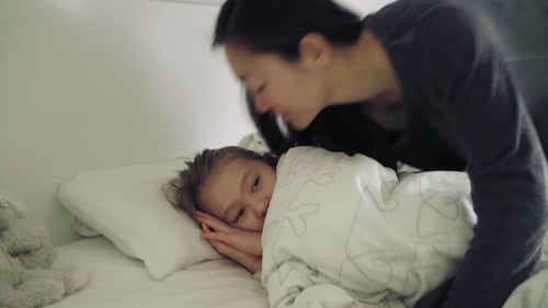 Mother and daughter in bed