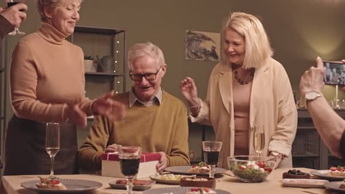 Friends Celebrate Birthday with Gift and Toast