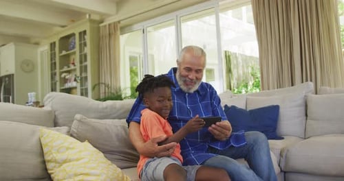 Grandfather and Grandson Using Smartphone at Home