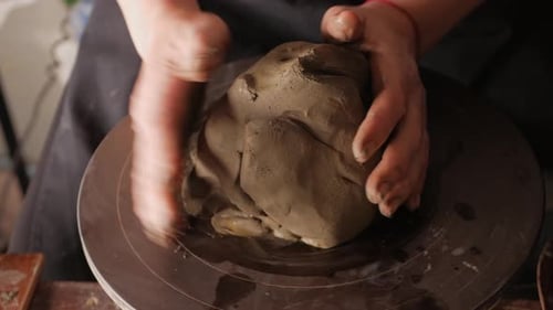 An Elderly Woman Senior Professional Potter in Workshop Makes Jug Out of Clay