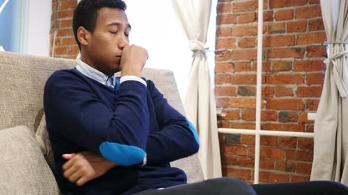 Young Adult Sitting with Chest Pain, Discomfort