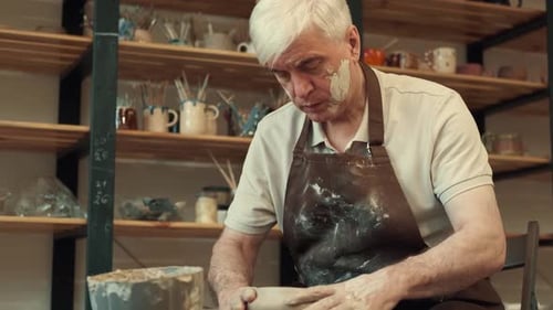 Man Shaping Clay Pot on Pottery Wheel