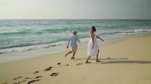 Happy Young Couple Having Fun on Sandy Beach