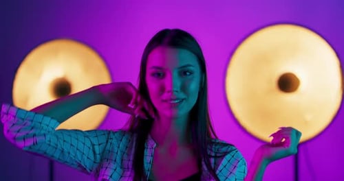 Stylish Woman Posing in Colorful Studio Lighting