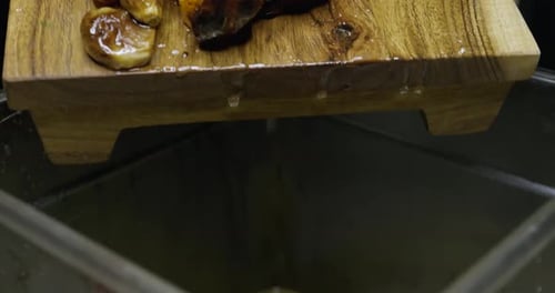 Chef Discards Cooked Vegetables into a Container