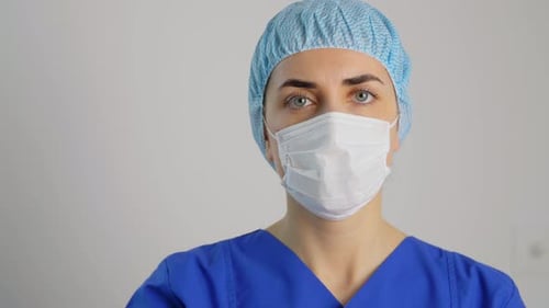 Doctor or Nurse in Face Mask Showing Stop Sign