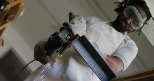 Man Cuts Metal Beam with Power Tool