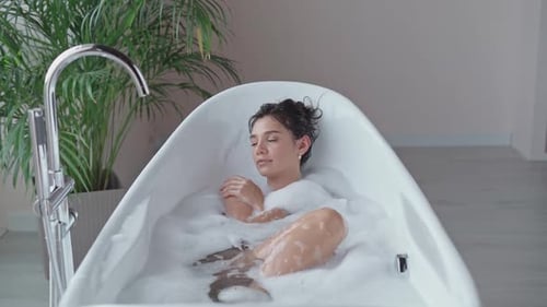 Woman Relaxing in a Modern Bathtub