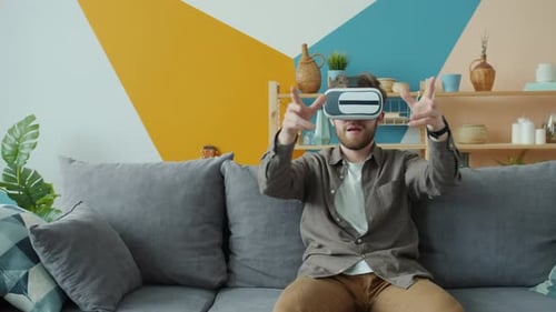 Man Experiencing Virtual Reality on Couch at Home