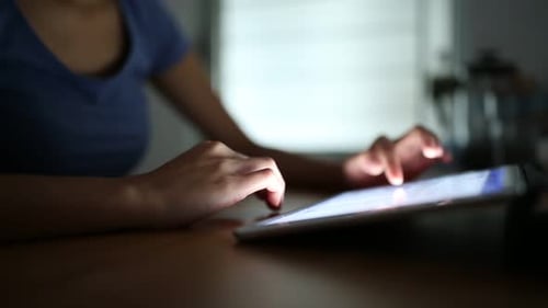 Woman using digital tablet computer at home