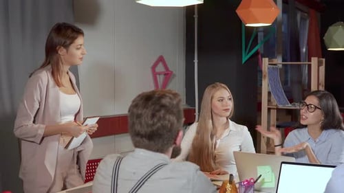 Team Meeting Around Table in Modern Workplace