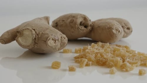 Slow tilt on Zingiber officinale and crystallized cubes 4K 2160p 30fps UltraHD footage - Candied an