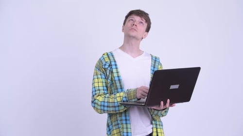 Young Adult Types on Laptop and Thinks