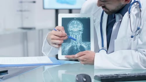 Close Up Shot of Doctor Hands Explaining Something About a X Ray Scan on a Digital Tablet PC