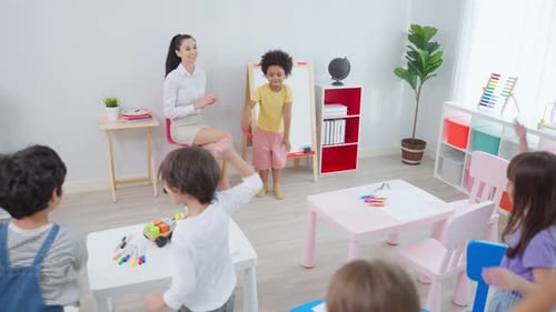 Enthusiastic Children Learning in a Bright Classroom