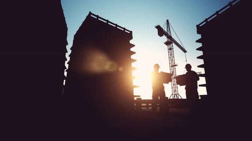 Silhouetted Construction Site with Engineers and Moving Crane