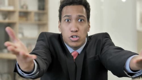 Upset Young Adult Arguing and Gesturing in Office