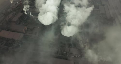 Epic Aerial of High Pipes with Smoke Emission. Plant Pipes Pollute Atmosphere. Industrial Factory