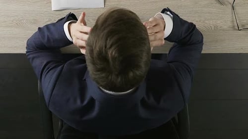 Businessman Sitting at Office Desk and Rubbing Temples, Overwhelming Pressure