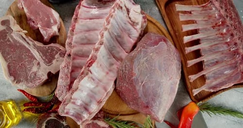 Fresh Raw Beef and Ribs on Cutting Boards