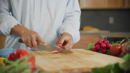 Close up shot of man cutting radish