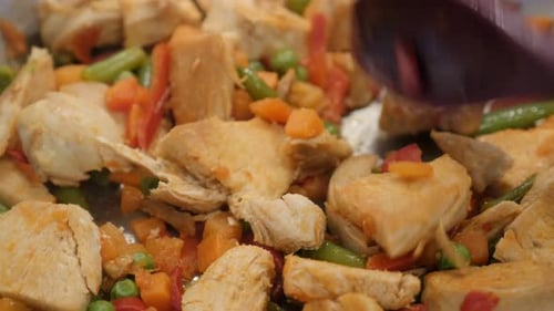 Close-up of tasty lunch in the frying pan 4K 2160p 30fps UltraHD video - Colorful mix of frozen vege