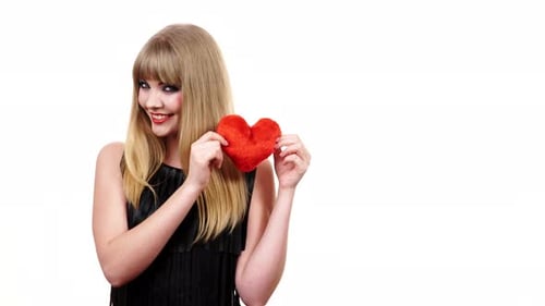 Woman Holds Red Heart Against White Background
