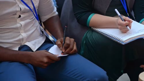 Closeup People Hands Writing Notes in Notebook Sitting in Conference Hall Listening to Lecture Irrl