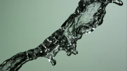 Water pouring and splashing in ultra slow motion 1500fps on a reflective surface - WATER POURS