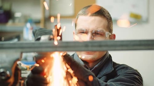 Angle Grinder Cutting Metal at Workshop