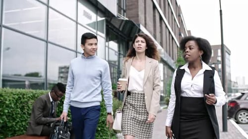 Business Colleagues Walking and Talking Outside Office Building