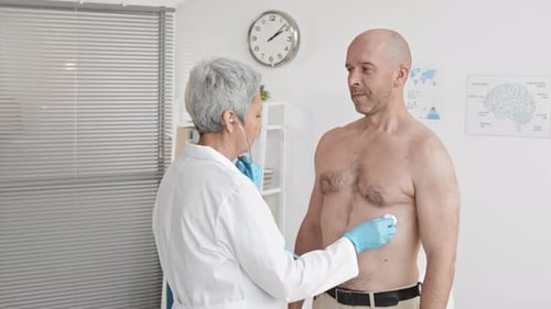 Doctor Examining Patient with Stethoscope in Clinic