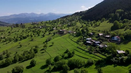 Scenic Mountain Village Amidst Rolling Green Hills