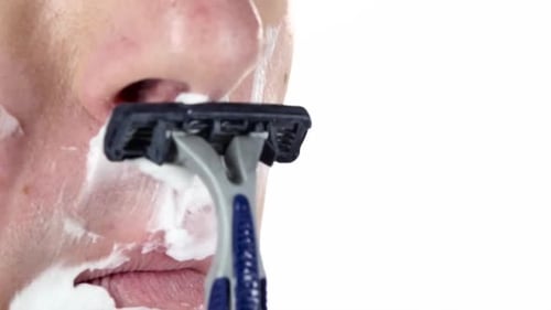 Guy Is Shaving His Face Under Nose. Close-up, White Background